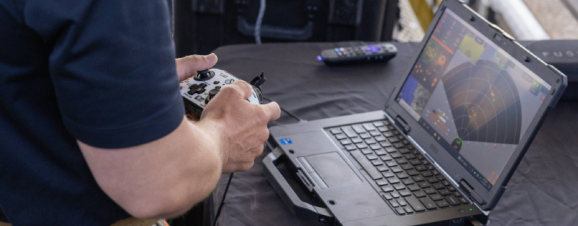 ADOA News Release graphic and a person with a video game remote watching radar on a laptop